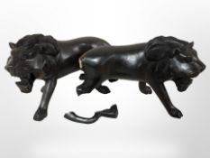 Two carved hardwood figures of African lions,