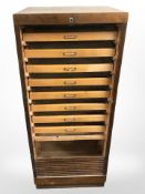 An early 20th century stained ply wood office shutter fronted cabinet,