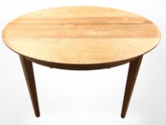 A 20th century teak extending circular dining table,