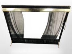 A brass and painted metal fire guard with chainmail curtain, width 97 cm.