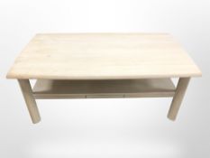 A contemporary beech coffee table, width 130 cm.