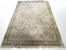 A machine made carpet of Persian design,