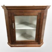 A 19th century glazed corner cabinet
