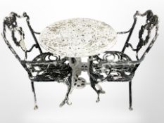 A weathered painted aluminium garden table and two chairs