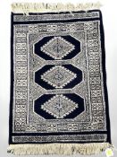 A Lahore Bokhara rug, Pakistan, 74 cm x 47 cm.