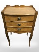 A Continental beech three drawer beside chest,