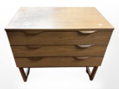 A 20th century teak three drawer chest,