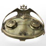 A brass and onyx Art Nouveau desk stand containing two inkwells, width 32 cm.