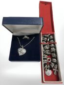 A white metal encrusted heart pendant,