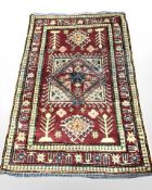 An Afghan rug of geometric design, 176 cm x 117 cm.