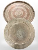 An antique Eastern embossed copper charger, diameter 71 cm, and a further modern example.