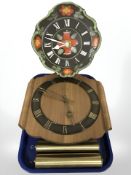 Two Junghans wall clocks and a brass and clear glass oil lamp.