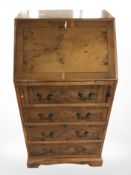 A reproduction yew wood lady's bureau,