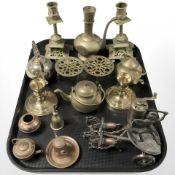 A pair of brass candlesticks, miniature teapots, trivets, similar copper plated items,