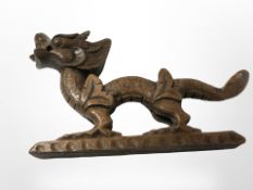 A carved wooden dragon ornament,