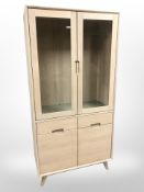 A contemporary light oak display unit,