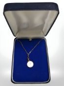 An Armani gold plated mother of pearl disc pendant on chain