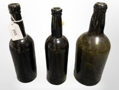 Three early 19th century green glass bottles, tallest 24 cm.