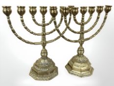 An ornate pair of brass menorah, height 26 cm.