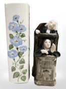A pottery figure of a judge and clerk, and an H & G Bavarian hand painted square vase,