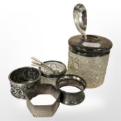 A silver teaspoon, three caddy spoons, three napkin rings,