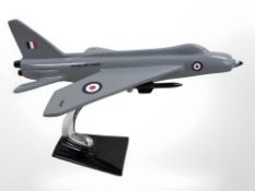 A metal painted figure of an RAF Lightning jet on stand.