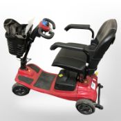 A Vogue mobility scooter with two keys, instructions, charging lead.