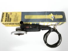 An angle grinder and a fold down security post in box.