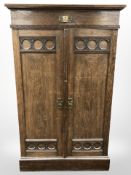 An early 20th century carved oak double door cabinet, 105 cm x 49 cm x 173 cm.