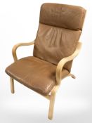 A Scandinavian bentwood tan leather upholstered armchair, width 63 cm.