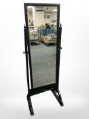 An ebonised cheval mirror.