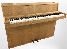An Andreas Christensen light oak mini piano,