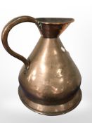 A copper two gallon jug and two copper beech handled bed warming pans