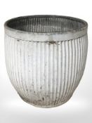 A galvanised bin containing a small quantity of carpentry tools, height 46 cm.