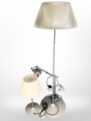 A contemporary floor lamp with glass shade,
