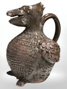 A terracotta jug in the form of a grotesque bird, height 23.