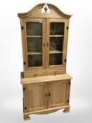 A light oak contemporary kitchen dresser with glazed cupboards above two drawers, width 90 cm,