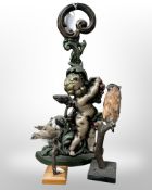 A painted cast iron door stop depicting a cherub, height 41 cm,