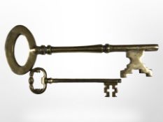 Two oversized brass keys,