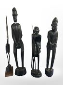 Three African carved hardwood statues, polished horn figure of a heron, tallest 39 cm.