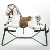 A vintage painted metal rocking horse.