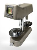 A enamelled metal bank coin scale