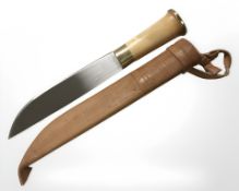 A hunting knife in tooled leather sheath,