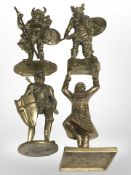 Two cast brass figures of vikings, a further depicting a knight and another of a highlander,