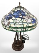 A Tiffany style leaded glass table lamp on patinated metal support, height 57 cm.