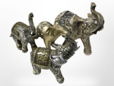 Four decorative elephant figures, largest 18 cm long.