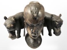 An African carved hardwood bust of a lady and a pair of hippo figures