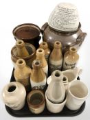 A group of antique stoneware bottles bearing advertising including Newcastle and South Shields