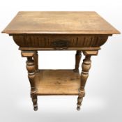 A 19th century oak two tier occasional table, fitted a drawer, width 58 cm.
