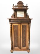 A 19th century walnut mirror backed double door cabinet, width 96 cm.